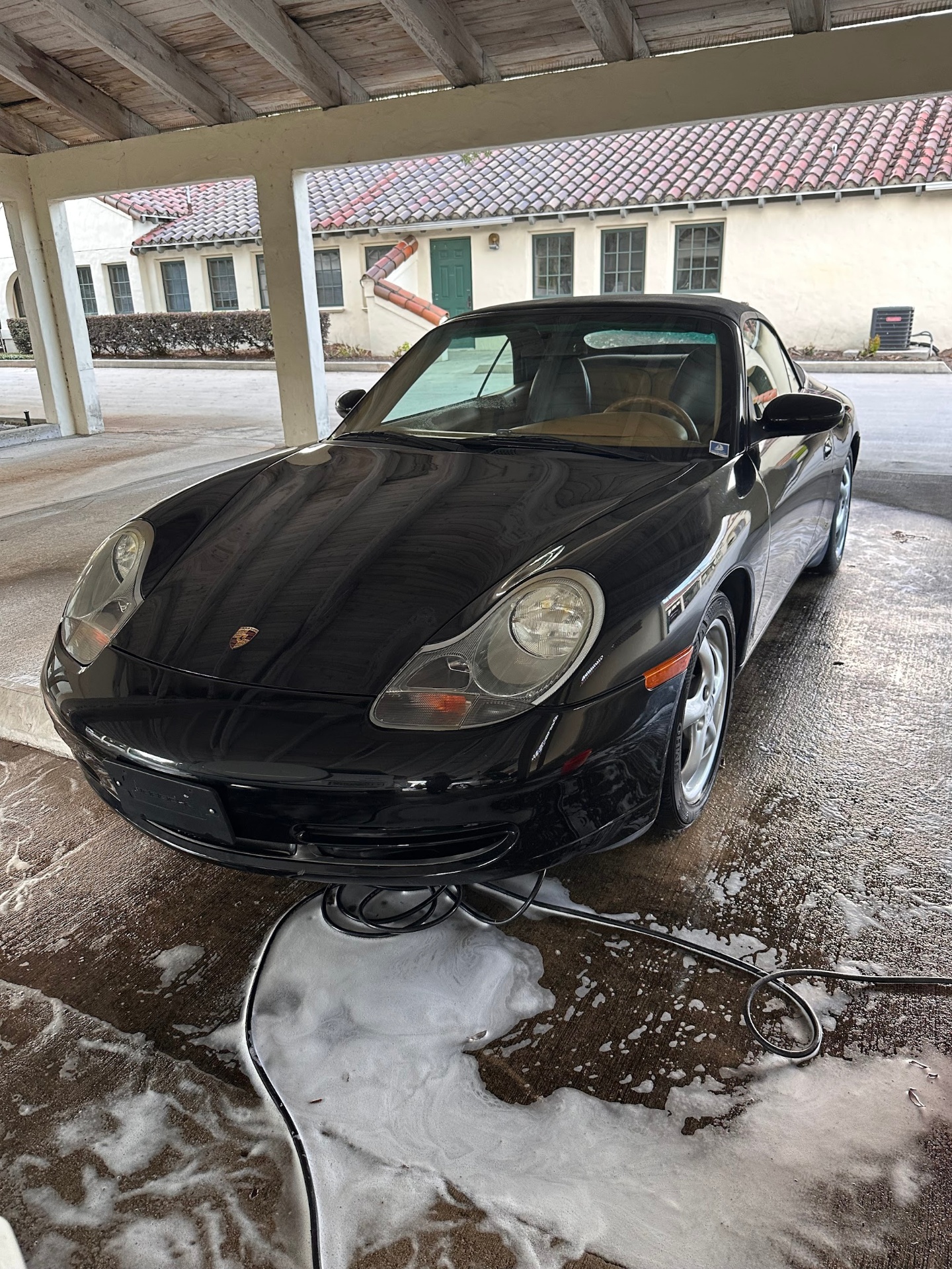 Black Porsche 911 convertible with glossy paint after wash